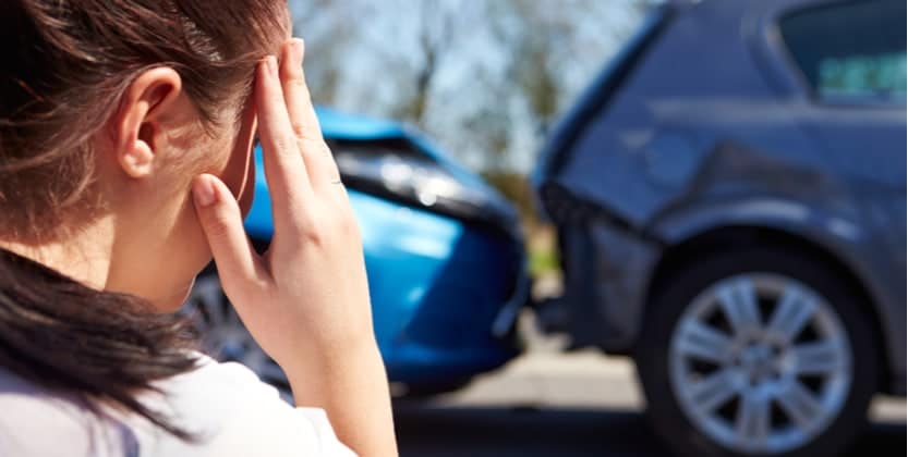 woman with a headache after being in a type of car crash