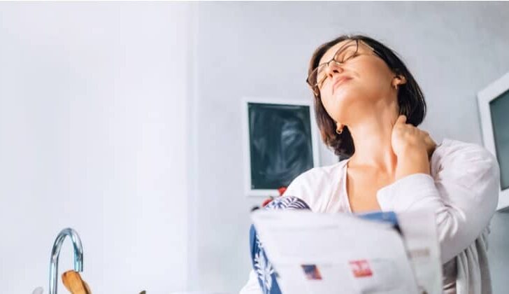 Woman stretching injured neck