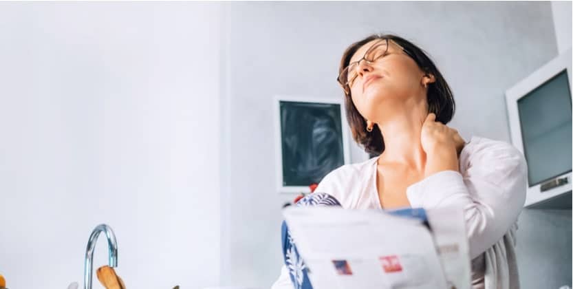 Woman stretching injured neck