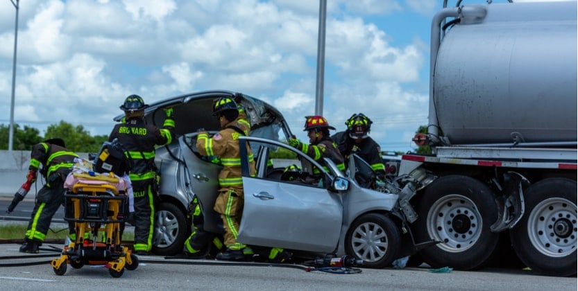 Broward County emergency services rescuing car accident victim from damaged vehicle