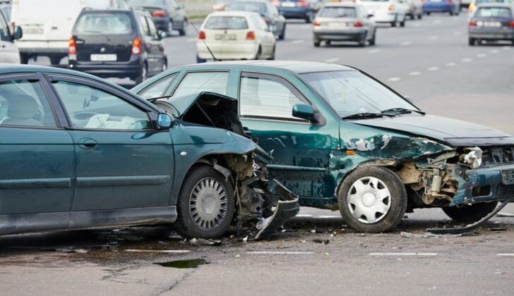 Two small green cars involved in a head-on collision on the highway in Fort Lauderdale