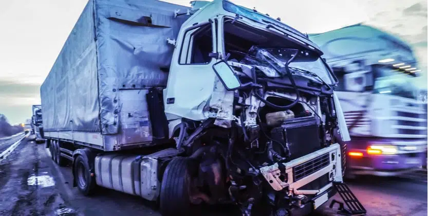 Semi-truck with crushed front fender attests to how many truck accidents happen a year in Florida