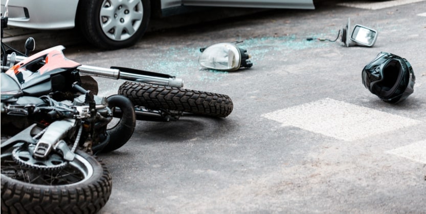 Shattered glass and crumpled motorcycle after a motorcycle accident