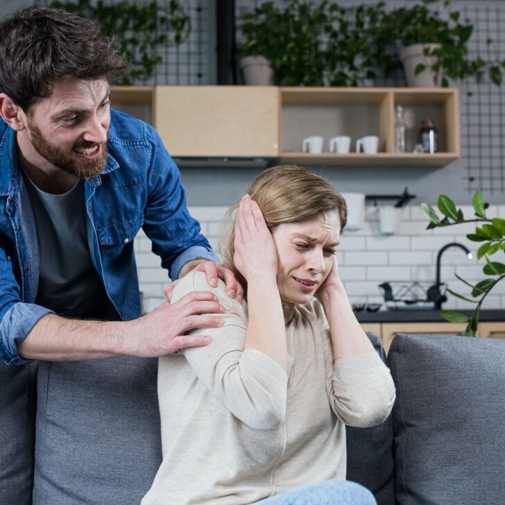 Domestic violence. Family conflict. A man shouts at a woman at home.
