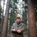 forester man conducts monitoring in pine national park. environmental Protection. forest industry