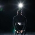 Kidnapped man sitting on chair with tied hands