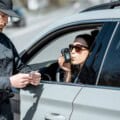 Policeman checking woman driver for alcohol intoxication