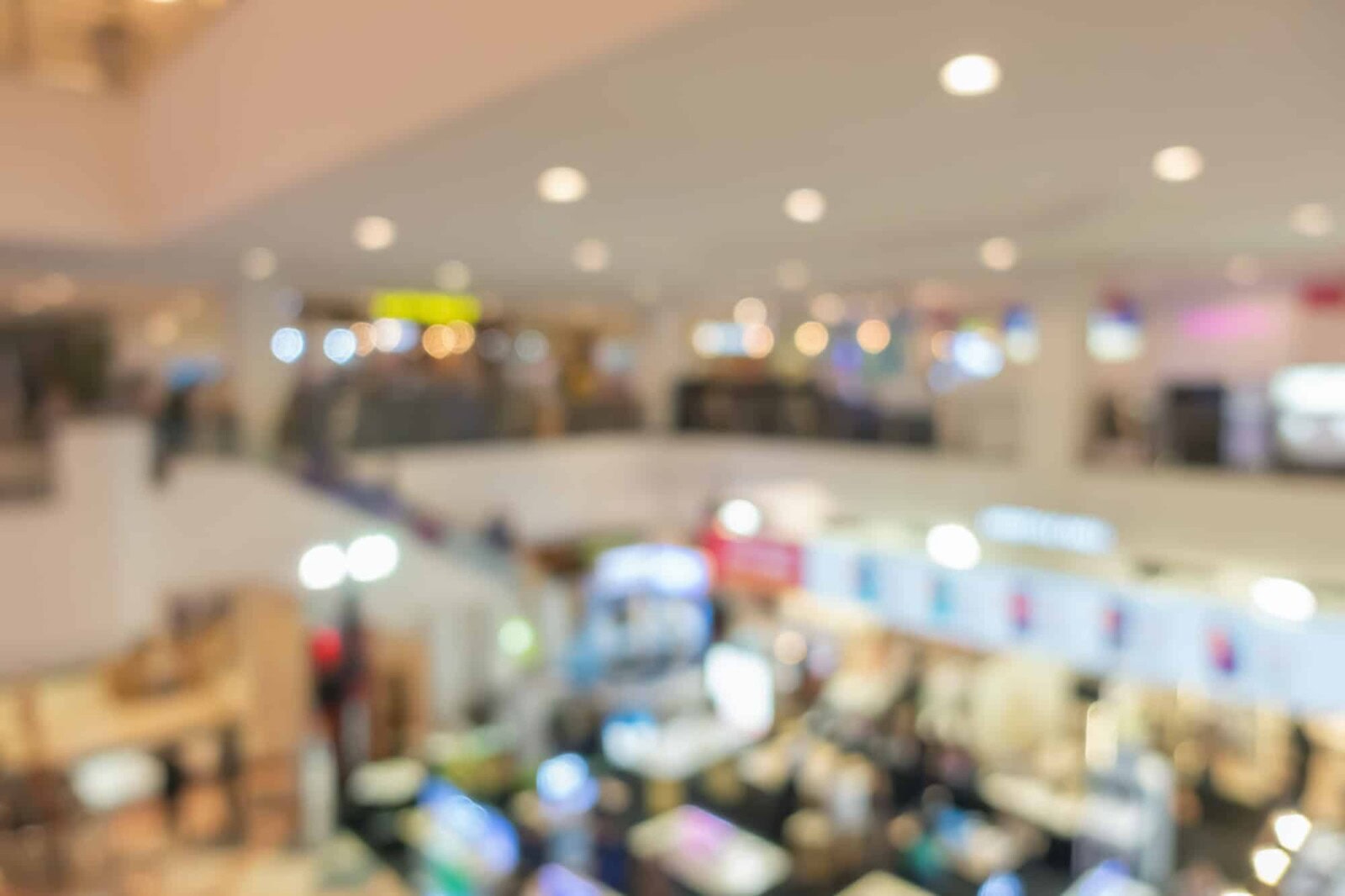 Abstract bokeh blurry background of retail shops in shopping mall or complex department.