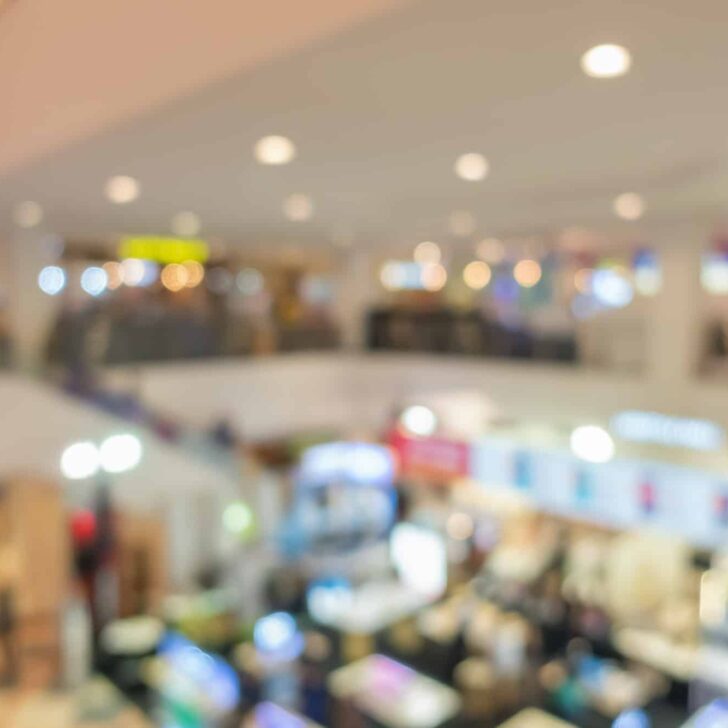 Abstract bokeh blurry background of retail shops in shopping mall or complex department.