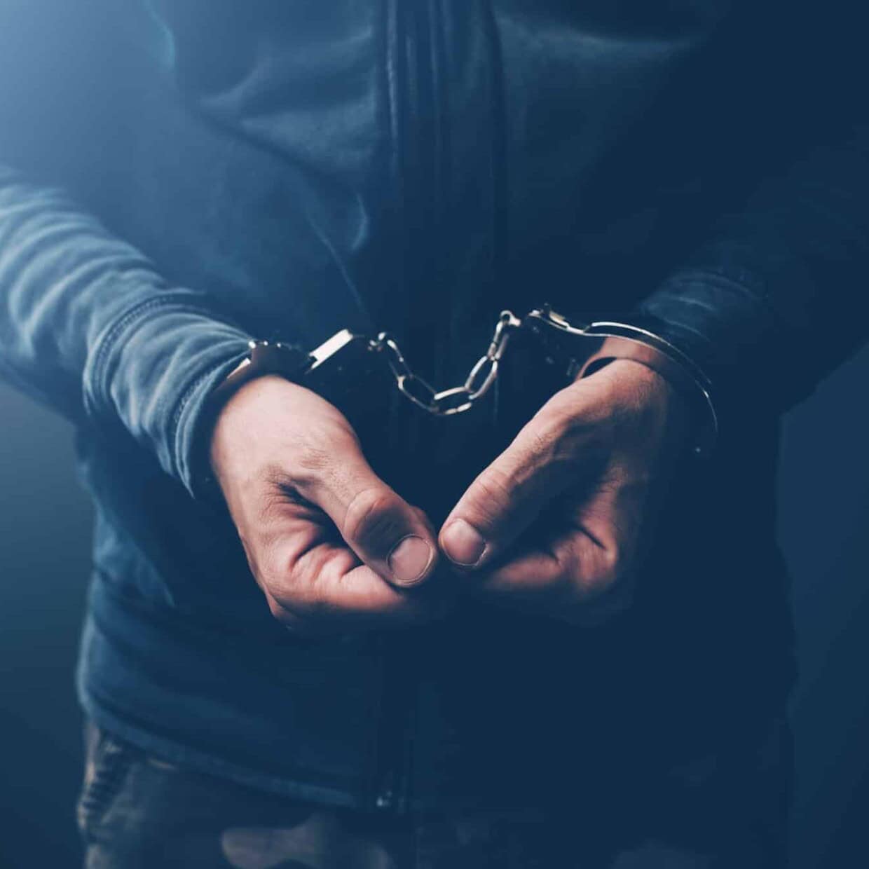 Arrested computer hacker with handcuffs