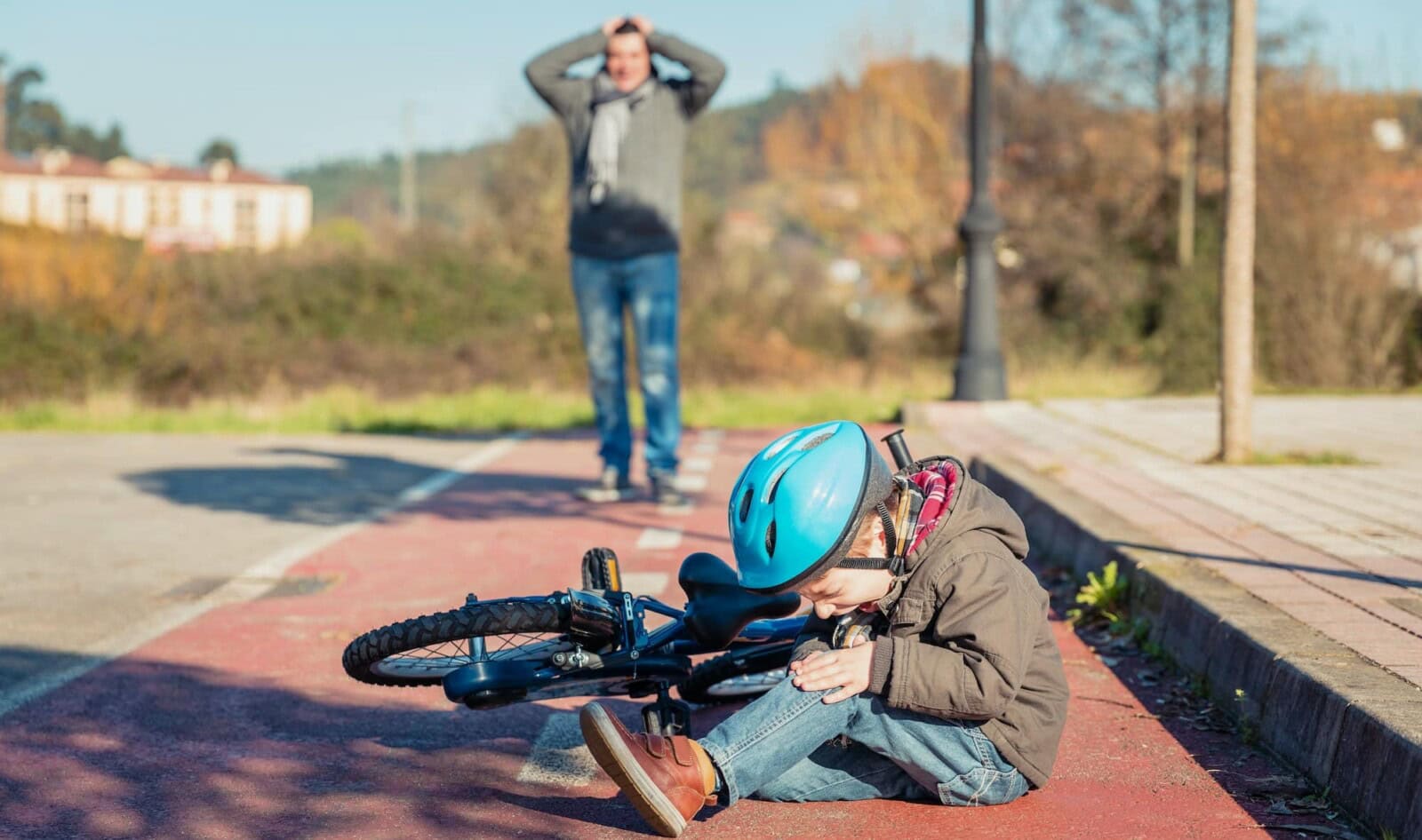 Boy with knee injury after falling off to bicycle