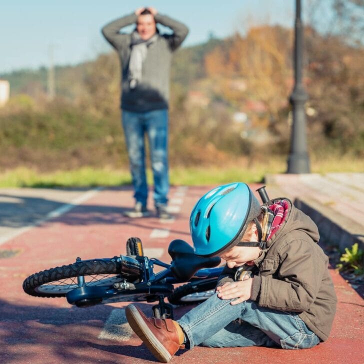 Boy with knee injury after falling off to bicycle