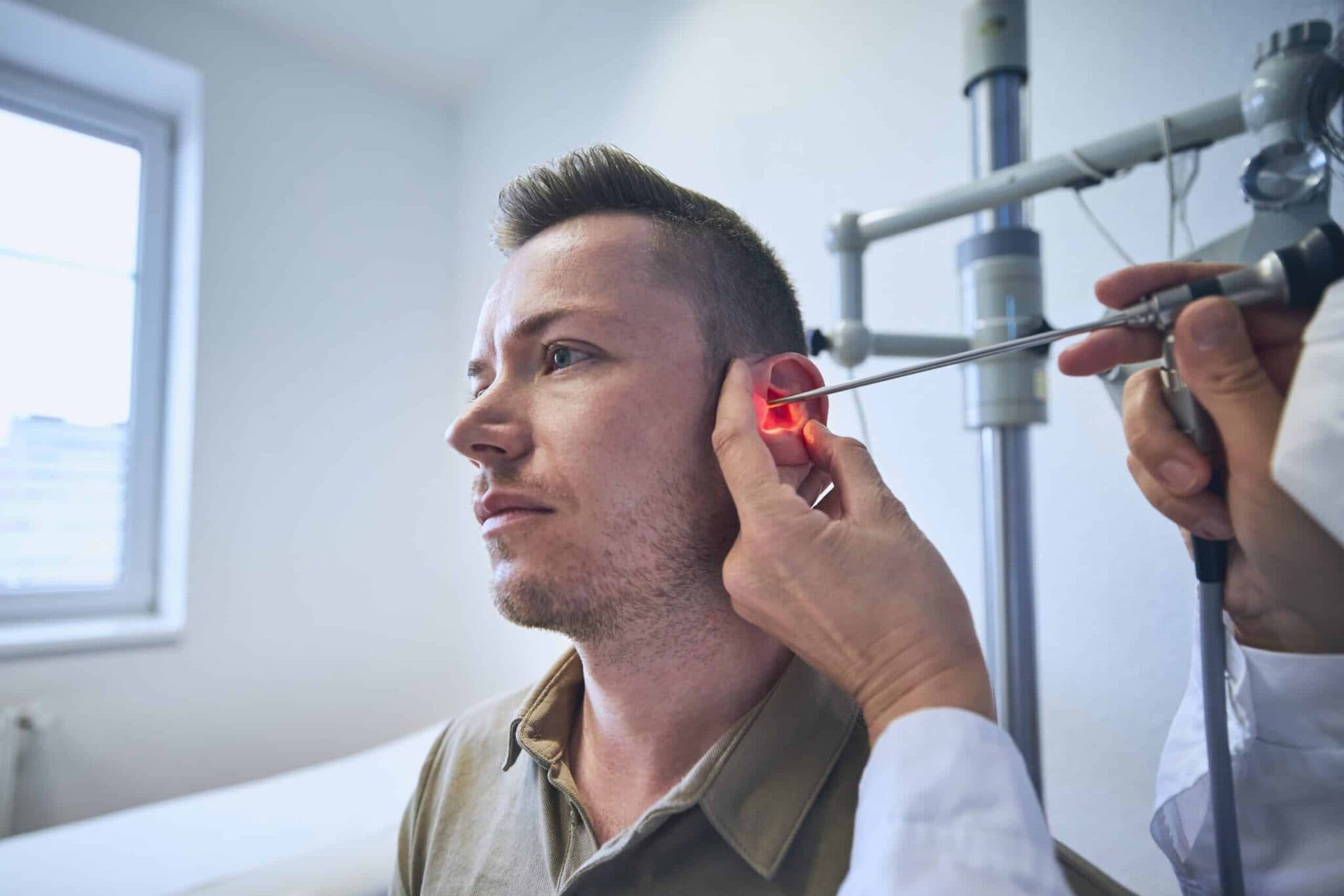 Doctor doing ear examination of young patient
