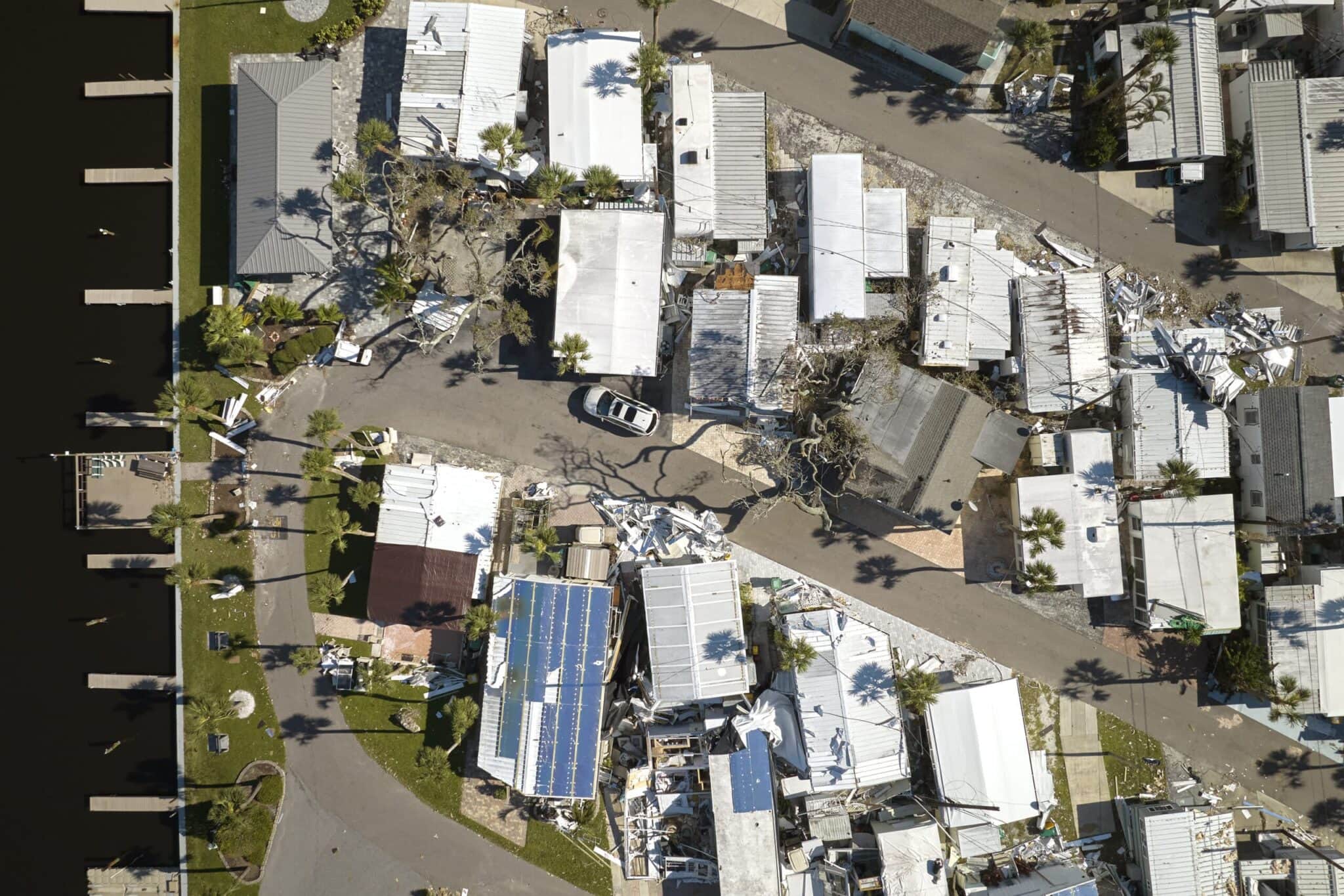 Hurricane Ian destroyed homes in Florida residential area. Natural disaster and its consequences