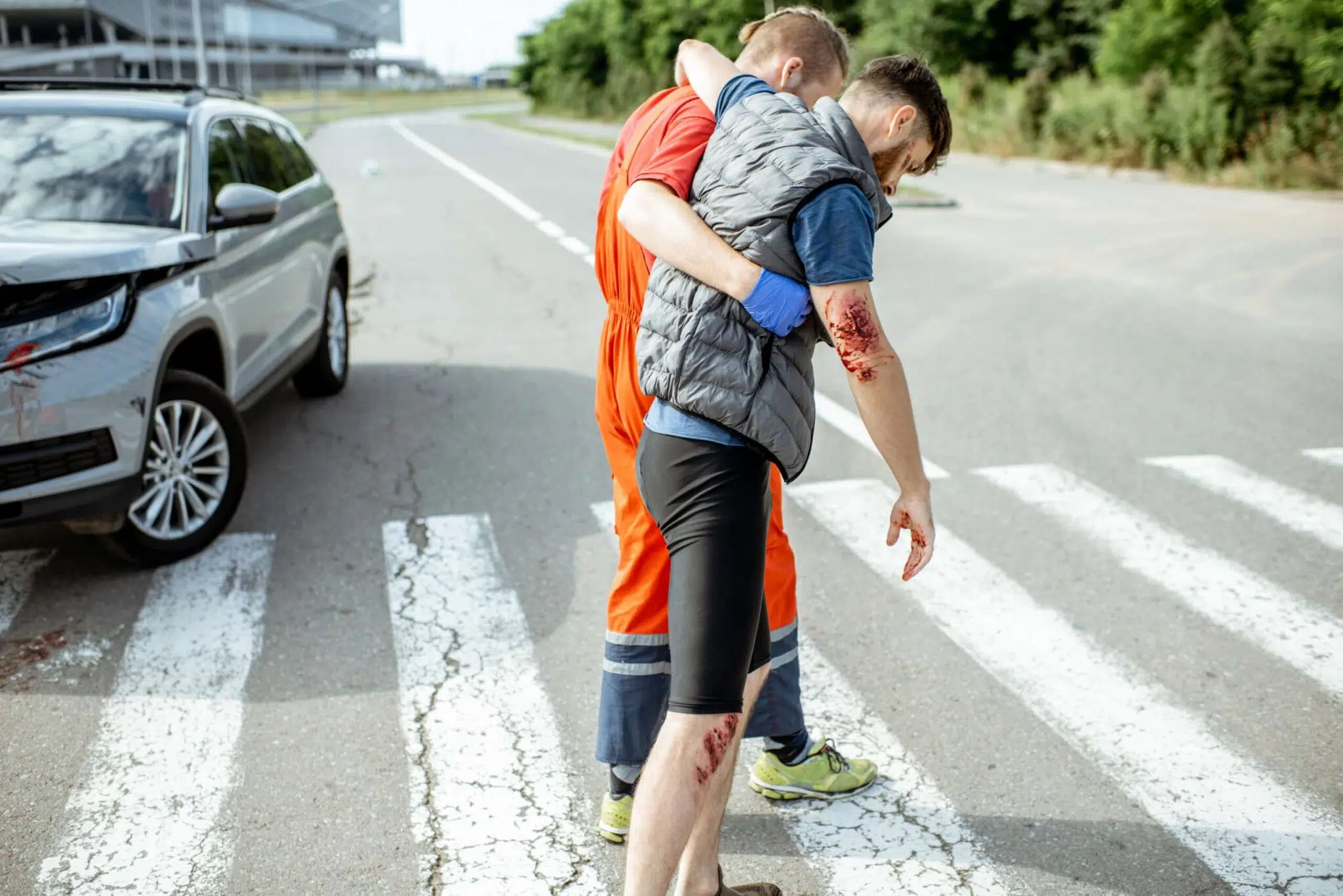 Medic walking with injured man after the accident
