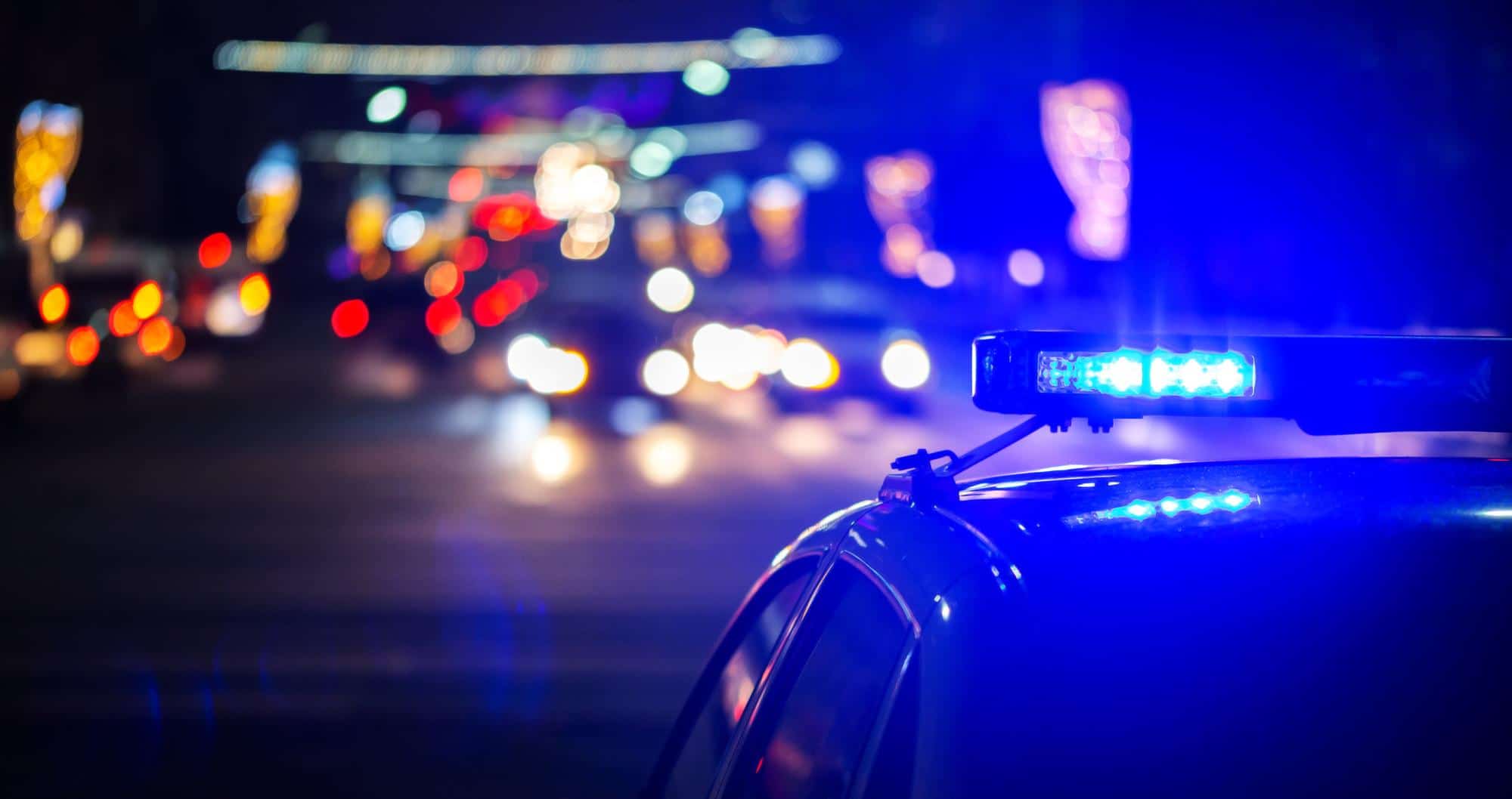 night police car lights city closeup with selective focus bokeh background blur