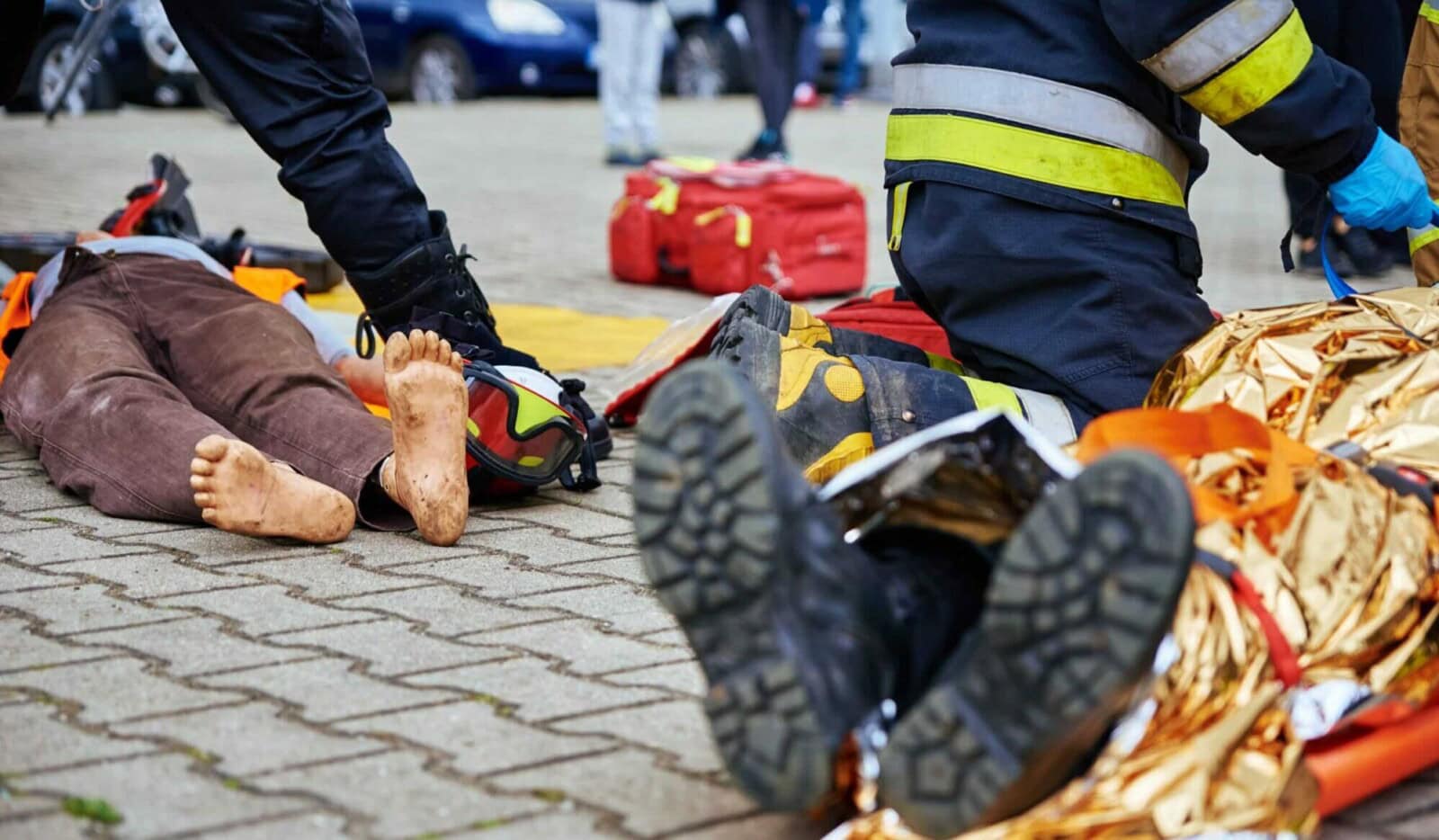 Rescuers provide first aid to the victim during car road accident