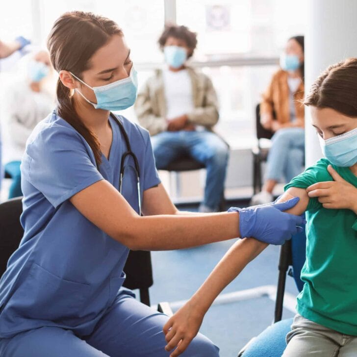 Teen Getting Vaccinated Against Covid, Nurse Applying Adhesive Bandage