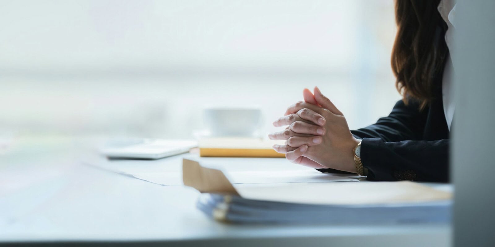 Close up clasped hands businesswomen negotiate at table, confrontation concept, negotiators