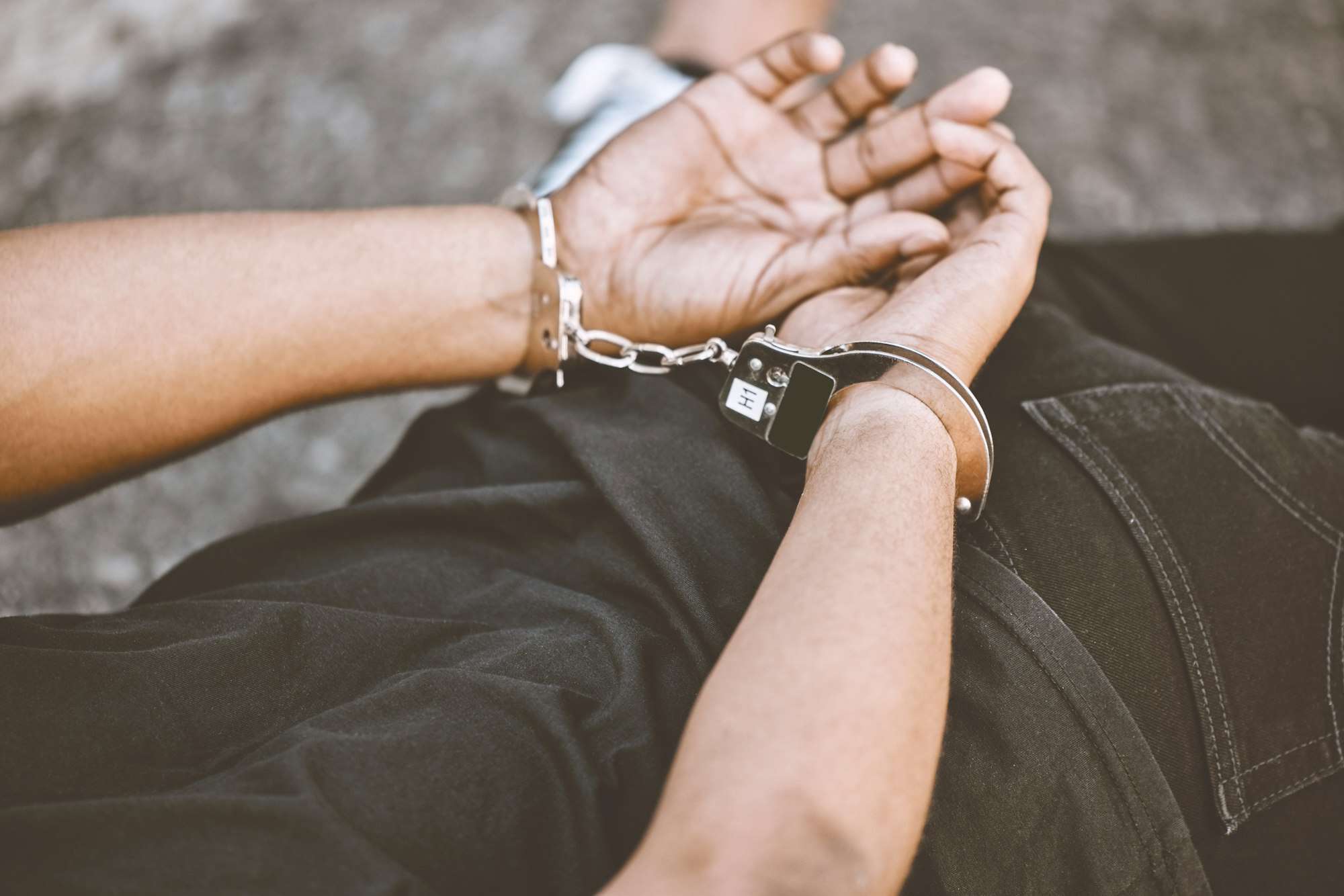 Arrest, justice and thief in handcuffs for fraud, violence and burglary after a suspected house rob