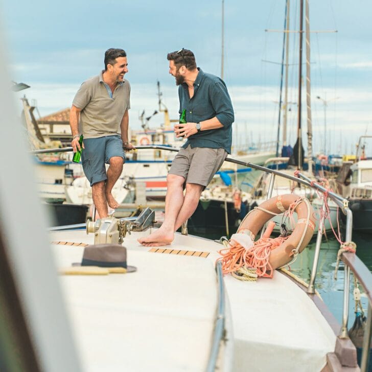 Friends Chatting on Boat Deck and drinking beers