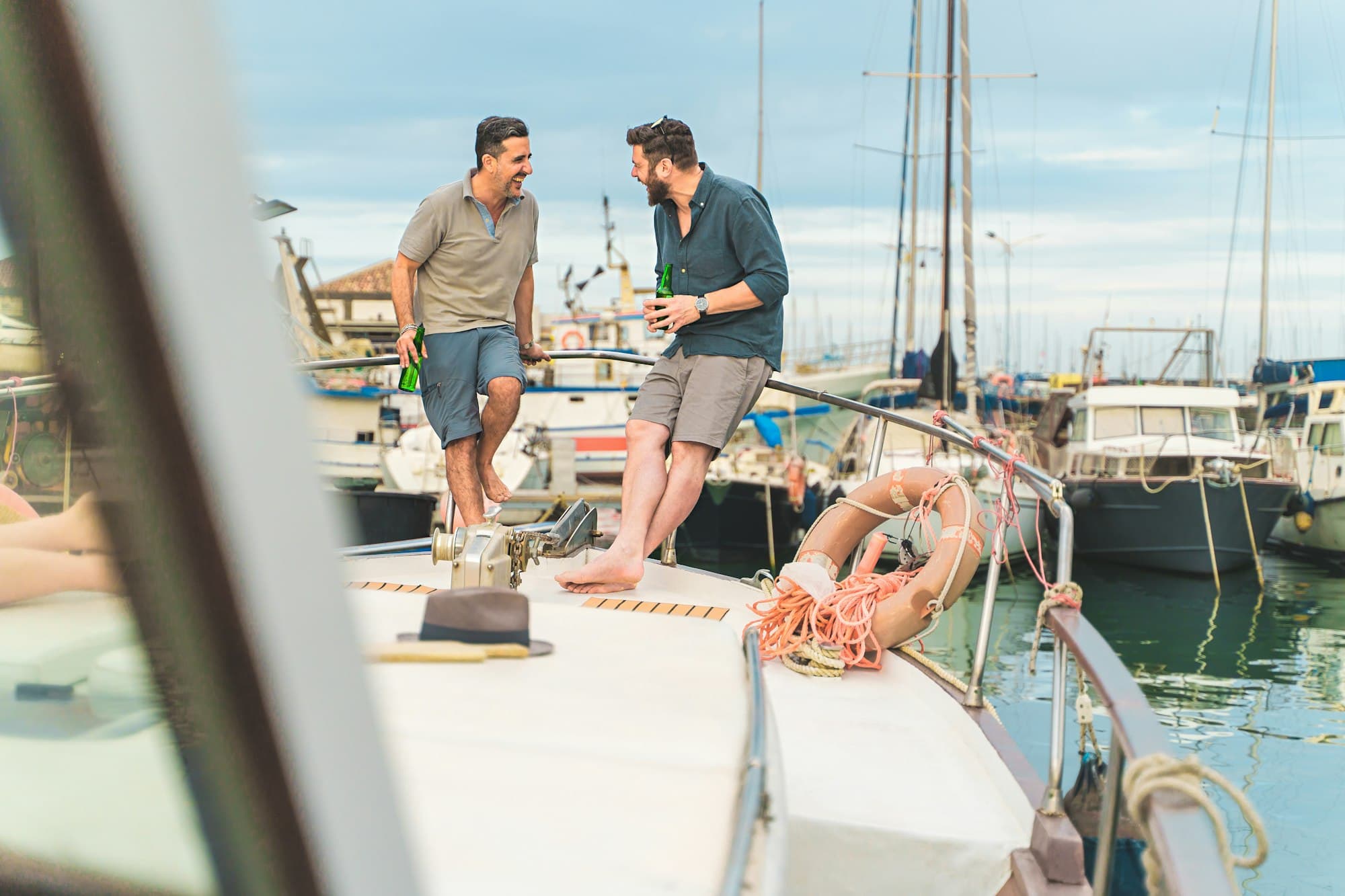 Friends Chatting on Boat Deck and drinking beers