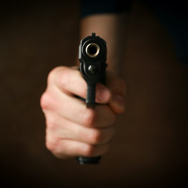 Man hold pistol. Selective focus. Robber. Violence