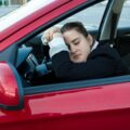 woman sleeping in car on drivers seat