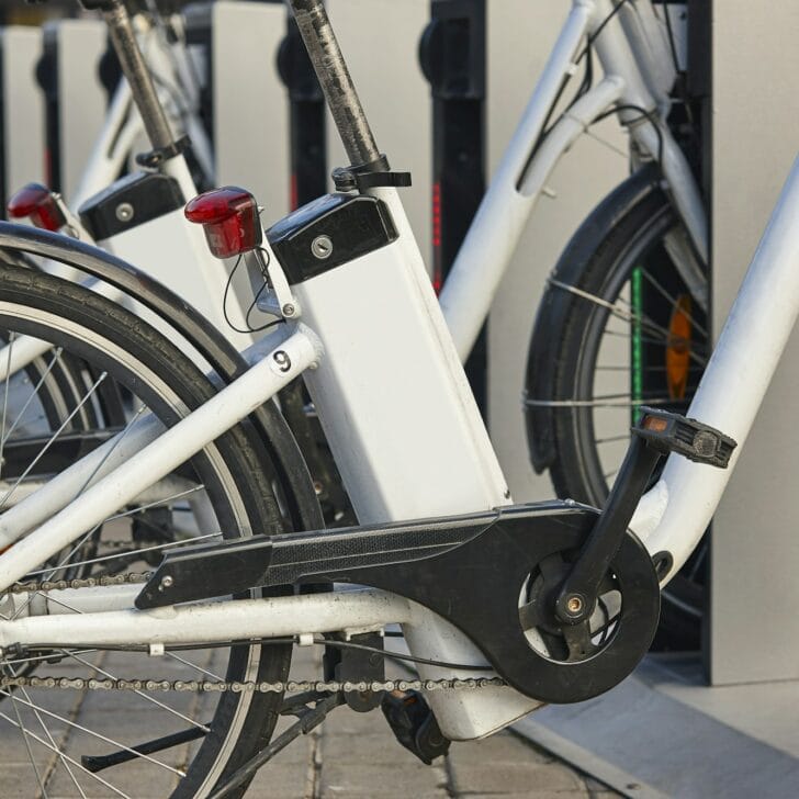 Urban electric bikes charging batteries in the city. For rent