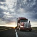 3/4 front view of a commercial truck on the road at sunset in eastern Washington, USA