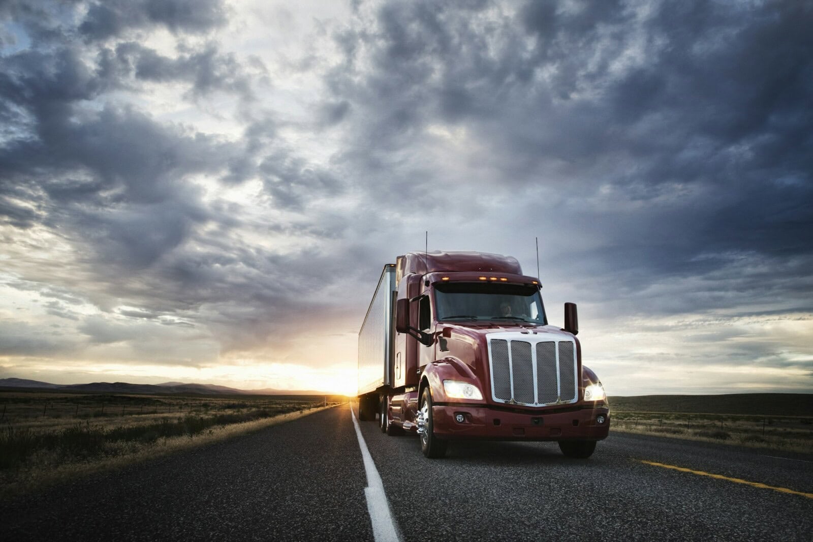 3/4 front view of a commercial truck on the road at sunset in eastern Washington, USA