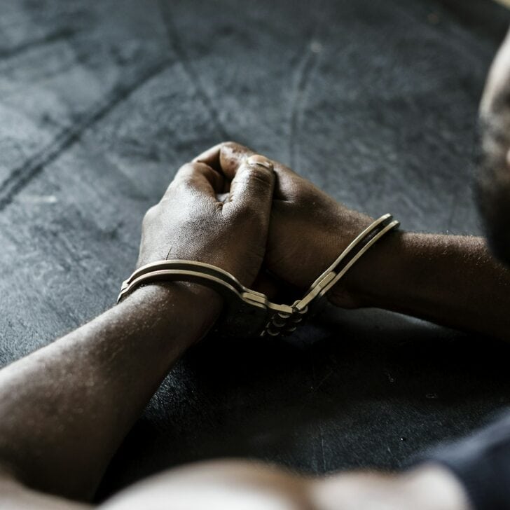 Arrested man with handcuffs on wrists