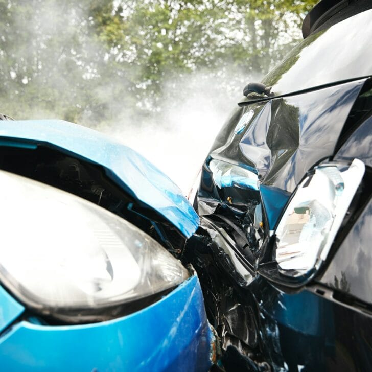 Close Up Of Two Cars Damaged In Road Traffic Accident