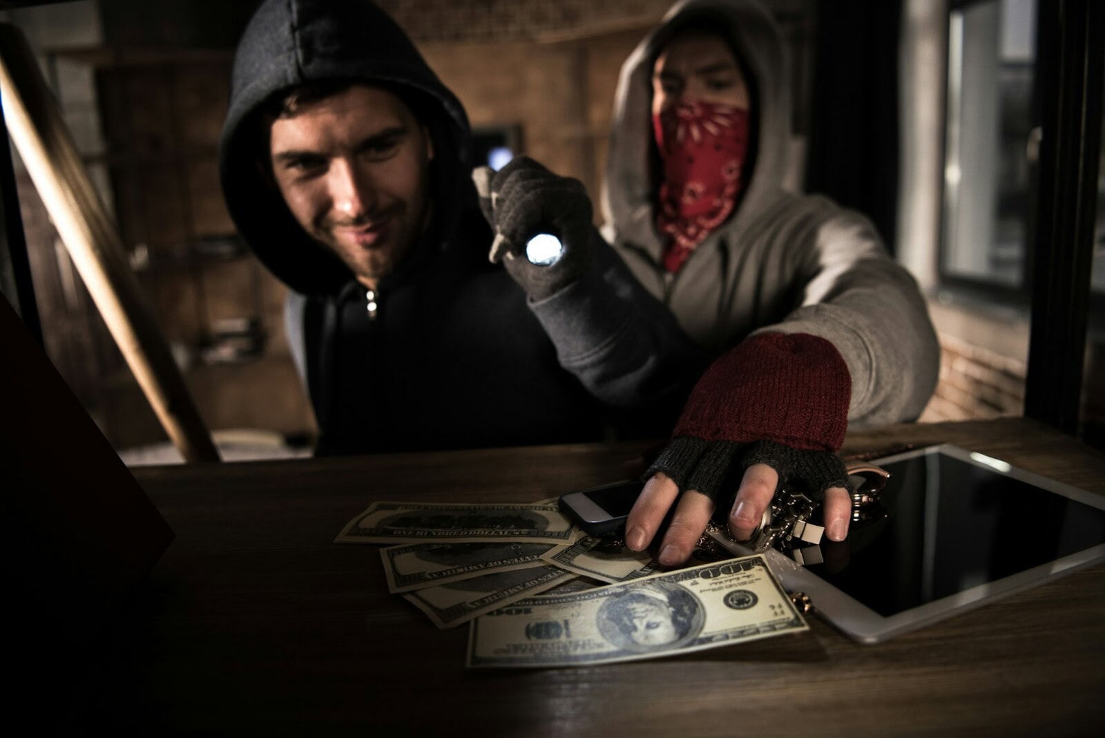 Two robbers stealing money and valuables, house robbery scene