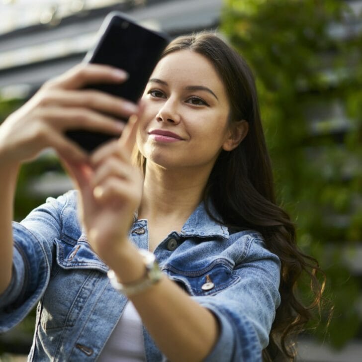 Caucasian travel girl shooting influence video vlog for sharing to social media