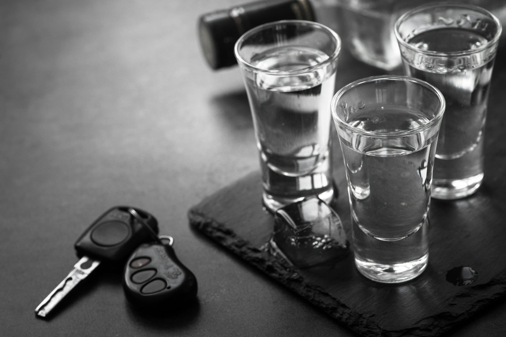 Vodka shot drink and car key.