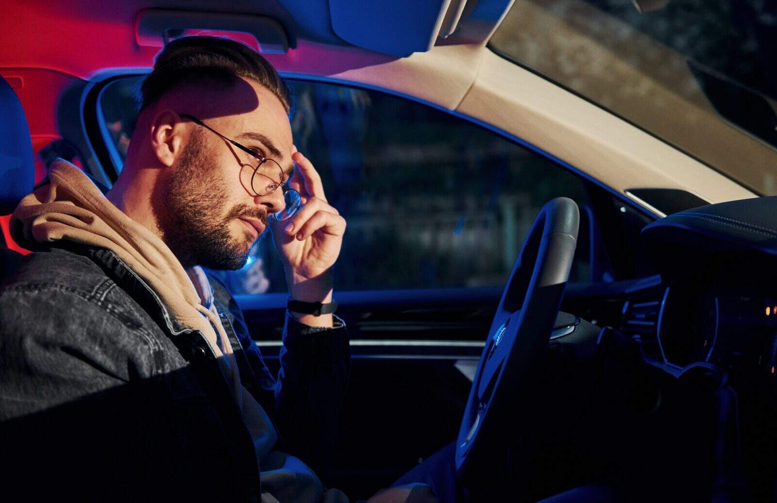 Handsome unshaved man in fashionable clothes stopped by police