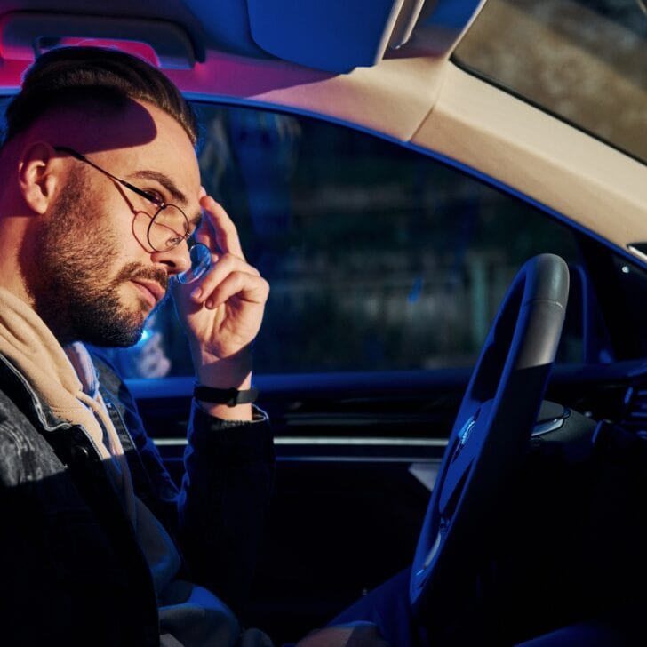 Handsome unshaved man in fashionable clothes stopped by police