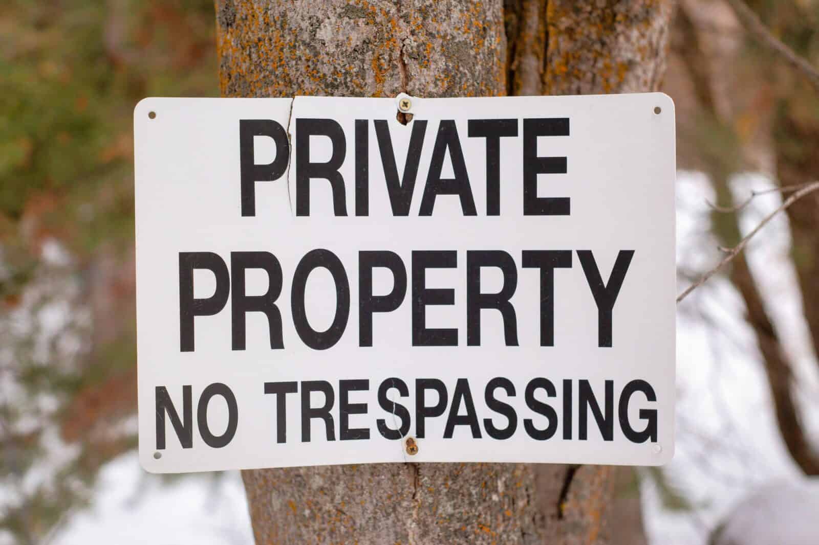 Private property no trespassing sign on a tree